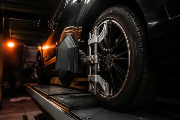 Alignment sensor clamped to a front wheel on the rack